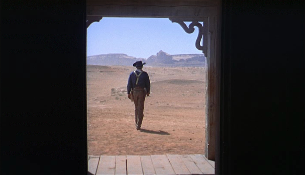 Western iconography — a gunman framed in a doorway against Monument Valley in The Searchers